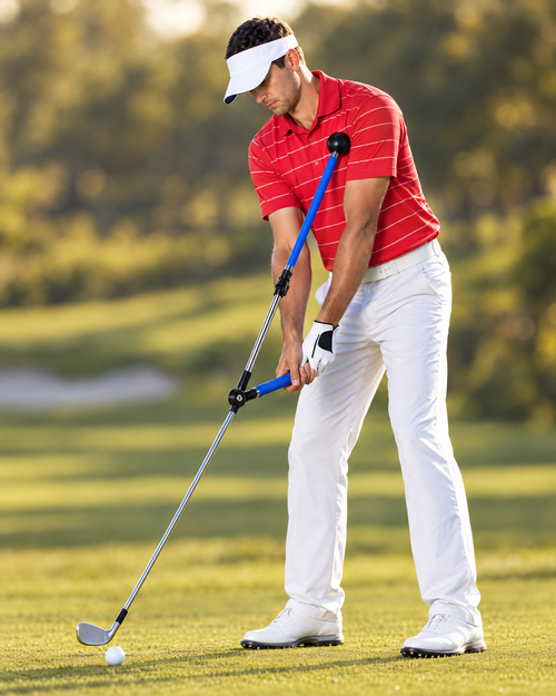 Golfer using the swing plane trainer on the course